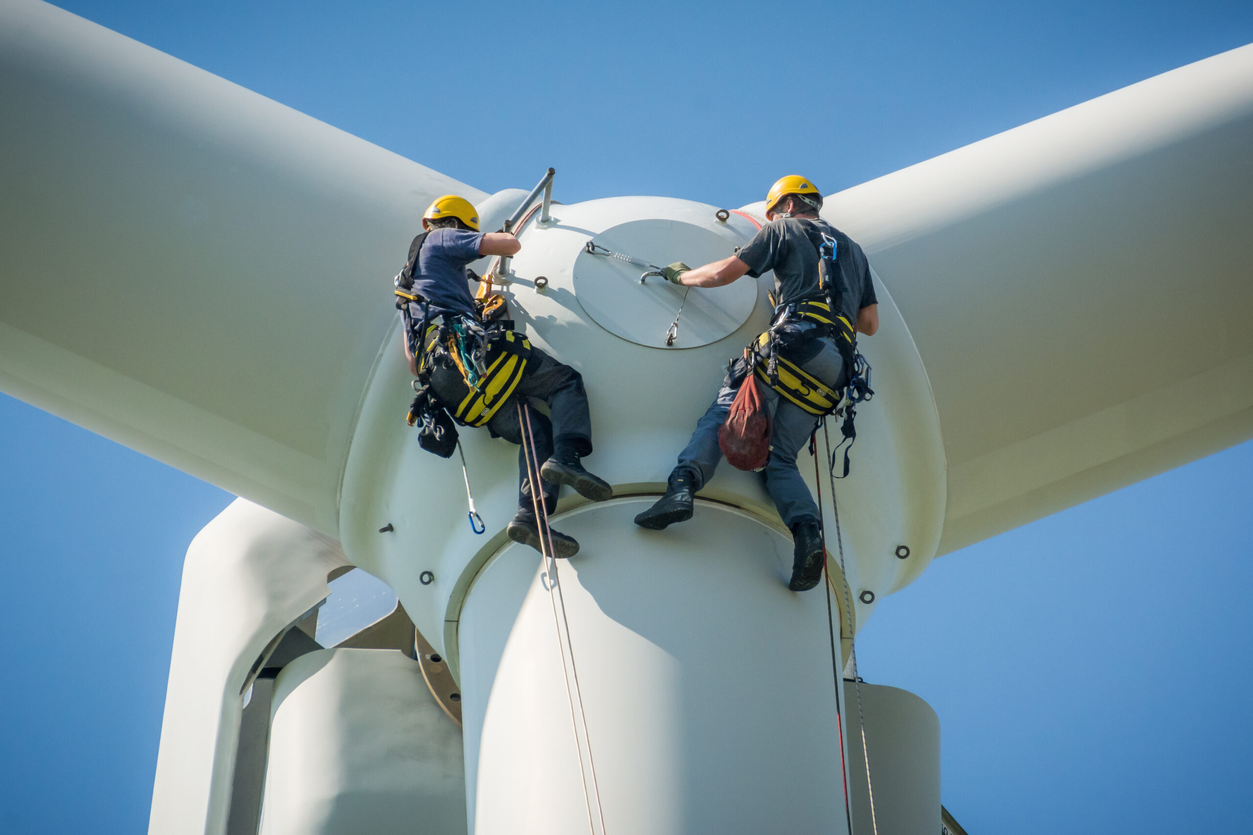 An image of wind tower demolition professionals working on a wind tower